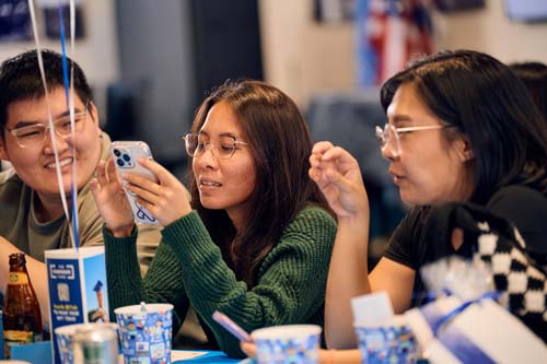 Alumni, from left, Derek Liu '17 and MBA '19, Jennifer Tolentino '18 and MBA '21 and Christine Vergara '19 discuss social media.