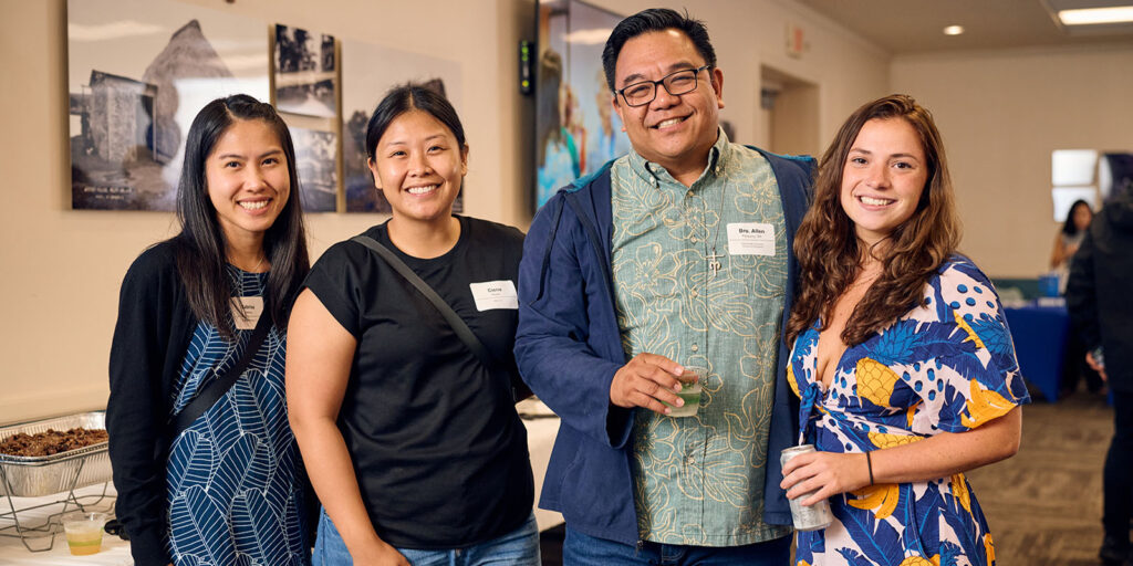 Alumnae, from left, Sabrina Hallabay '19, Ciena Alagao MBA '23 and Sarah Carroll "24, catch up with Bro. Allen Pacquing, SM.