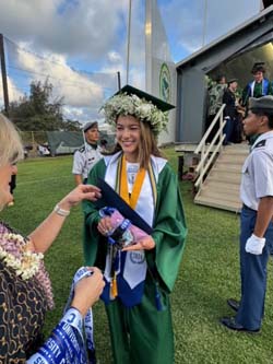 Dr. Janet Davidson presents a Kapaa High School senior with a special ribbon.
