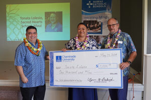 Llewellyn Young, Ph.D., superintendent of Hawaii Catholic Schools, left, and Chaminade's School of Business and Behavioral Sciences Dean, Dr. Dale Fryxell, present $1,000 check to Hawaii Catholic Schools’ Teacher of the Year winner Tonata Lolesio