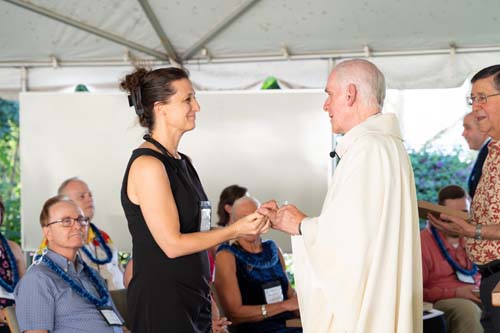 As part of the MEA Formation rituals, Fr. Martin Solma annoints the hands of Dr. Abby Halston.