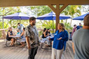Dr. Denise Dugan talks with recent alumnus Gabriel Zapata Berrios '24, who is now a student teacher for second graders in Kailua.