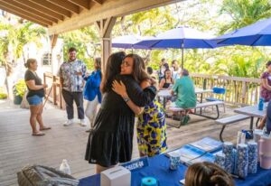 Reunion goers hugged as they met on the patio deck of Brogan Hall.