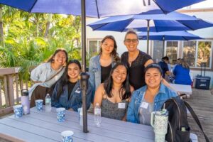 Katrina Roseler, Ph.D., Director of Teacher Preparation Programs and Associate Professor, standing right, posed for a photo with her former students.