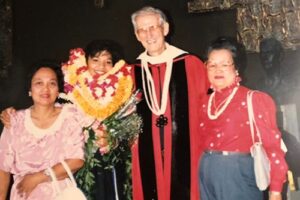 Draped in lei, Estela Derr poses with her mom, Estelita Tabangcura, Fr. Roesch and her aunt Pat.