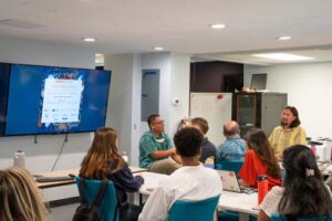 Students share their research with Kumu Kahoa Keahi-Wood.