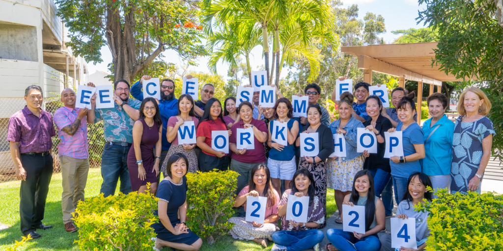 Chaminade President Dr. Lynn Babington, far right, and Greg Young President & CEO of HawaiiUSA Federal Credit Union, far left, pose with participants who held up the EECE Summer Workshop 2024 sign after completing the weeklong program.