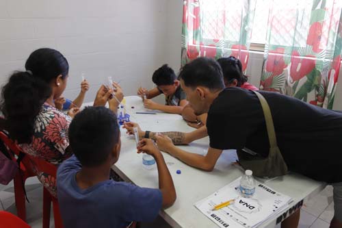 Chaminade Student Ambassador La‘a Gamiao helped students with science lab work.