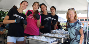 Chaminade President Lynn Babington, Ph.D., welcome back students with a special lunch served by some of the Women's Volleyball.
