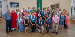 Bro. Ed Brink and Fr. Martin Solma with Deacon Michael Weaver, MPT ‘14 (fourth from left, standing) pose with Chaminade's Marianist Educational Associates at the end of the Spiritual Convocation.
