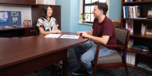 Danielle Masuda, Assistant Provost for Inclusive Excellence speaks with junior Caleb Cloud '25.