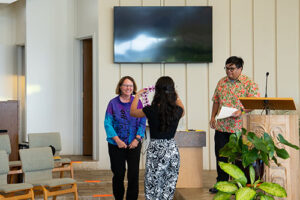 Dr. Therese Lysault was presented with a lei from Emmalee Bugado after Dr. Dustyn Ragasa introduced her to the audience.