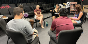 Cast members do a group reading in preparation for opening day.