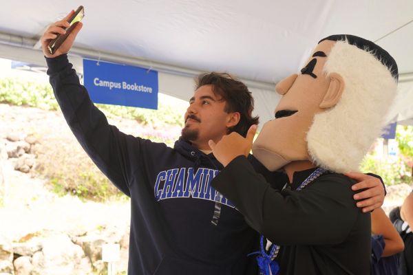 a student taking a selfie with Fr. Chami