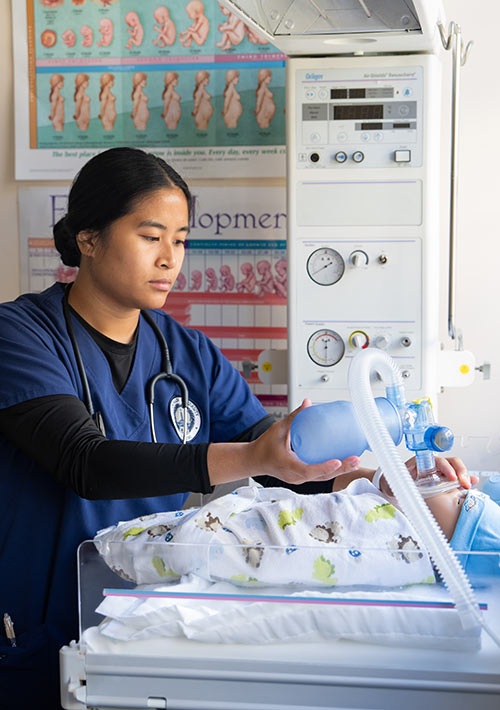 nursing student in a simulation lab delivery room