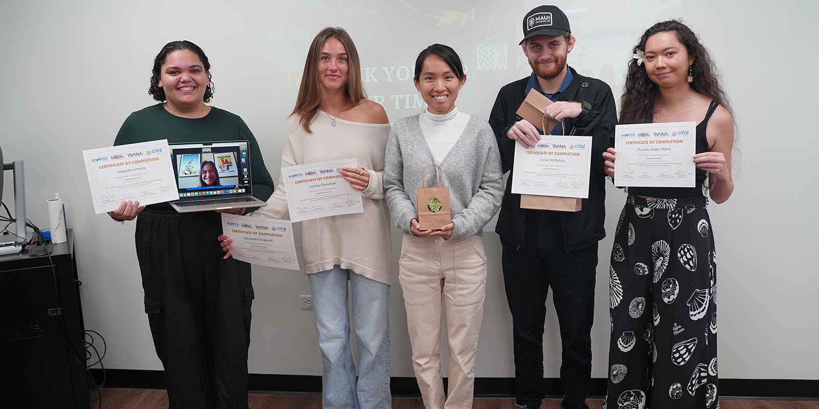 Plantoem founder Zoe Zhang, center, says Chaminade student's sustainable proposals are very viable. Team members included, from left, Aleeyah Lemons ’24, Alexandra Zingarelli ’24 (joining remotely from Chicago), Sydney Danielson ’25, Conor McMahon ’24 and Pūnohu Keahi-Wood ’25.